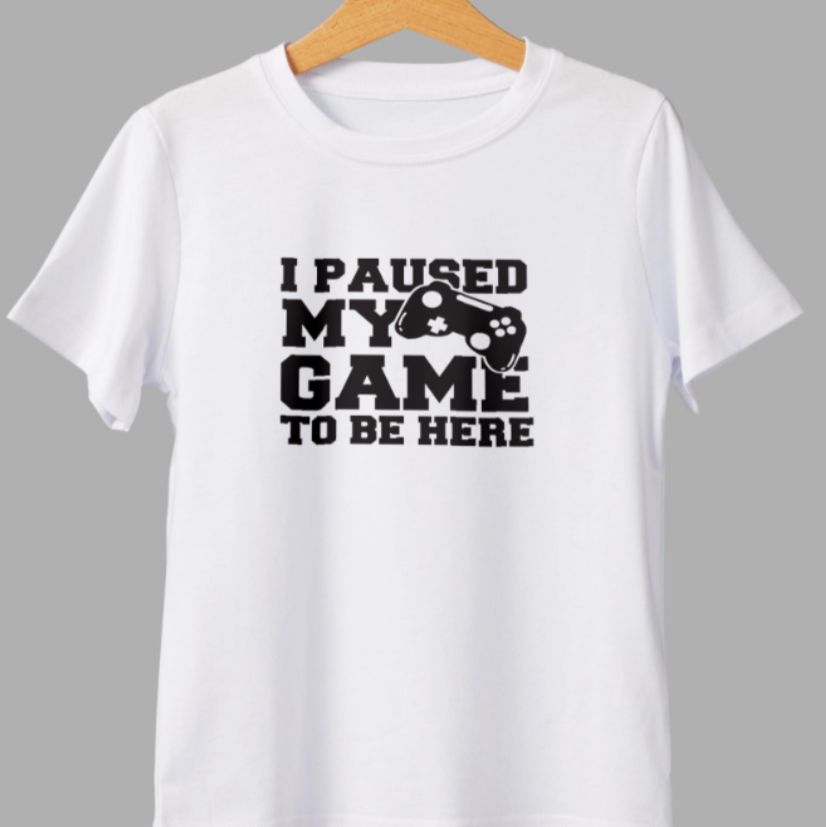 White t-shirt with black text and graphic on a gray background