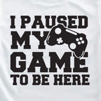 White t-shirt with black text and game controller graphic on a white background